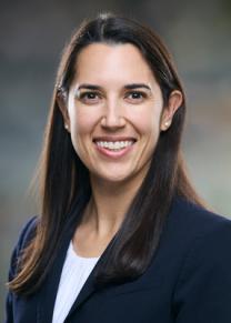 3/4 profile, woman with brown hair and a navy suitcoat